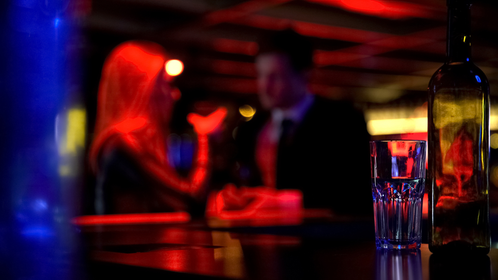 couple on a date in a dark bar